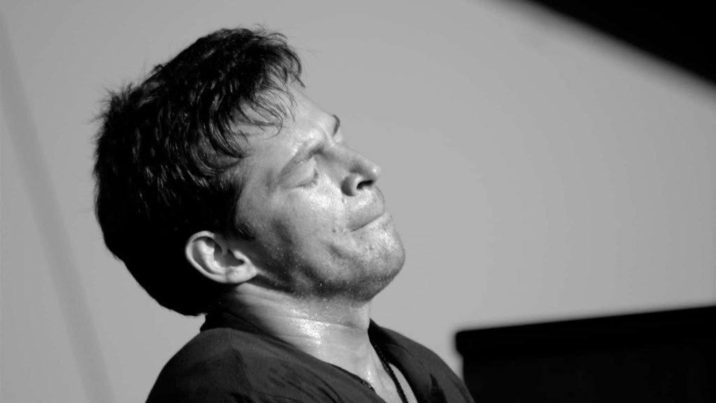 Harry Connick Jr live black and white portrait passionately performing on stage wallpaper background