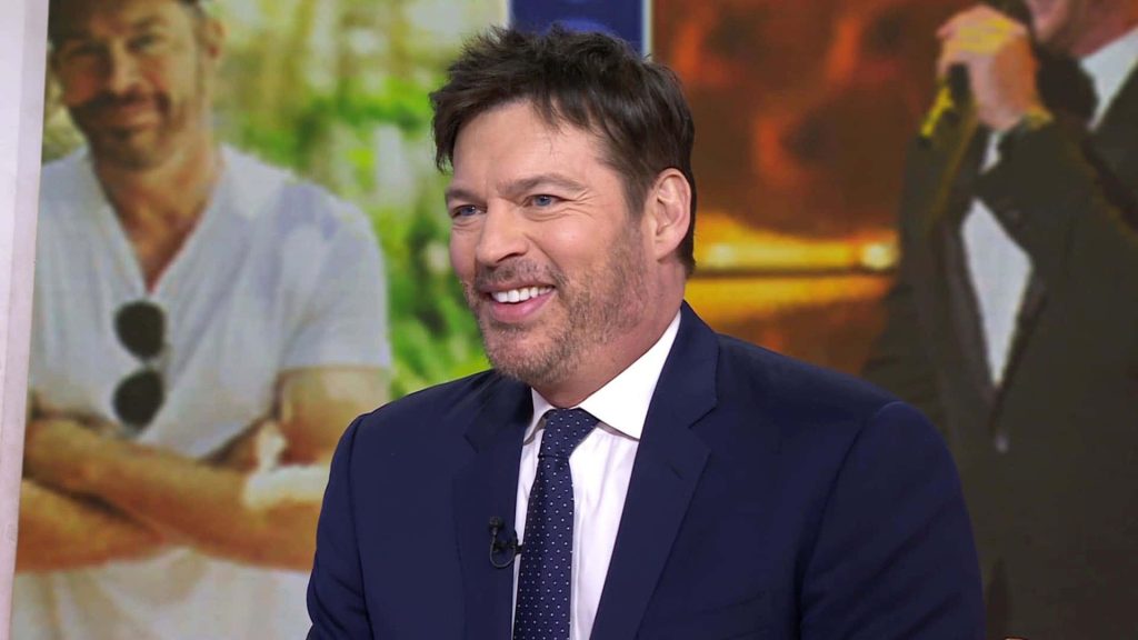 Harry Connick Jr in navy suit and polka-dot tie smiling bright studio portrait wallpaper background