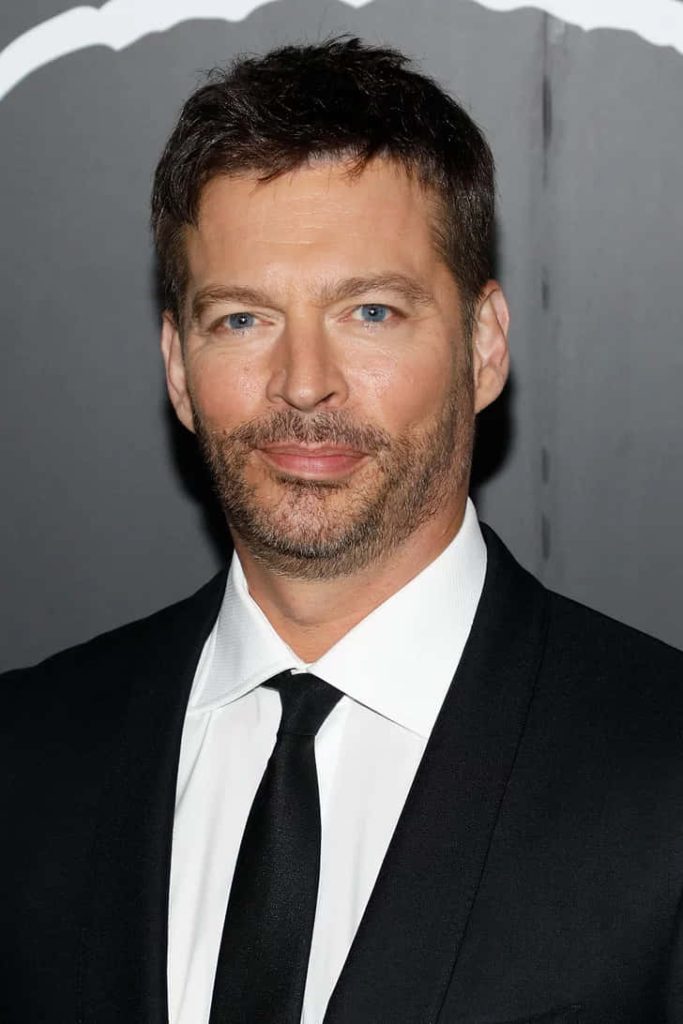 Harry Connick Jr. portrait in sharp suit with blue eyes and subtle smile on dark background wallpaper