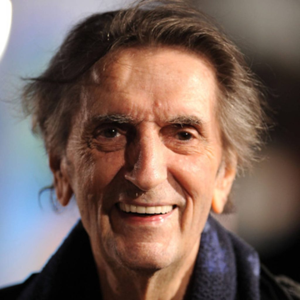 Close-up portrait of legendary actor Harry Dean Stanton smiling with blurred background wallpaper