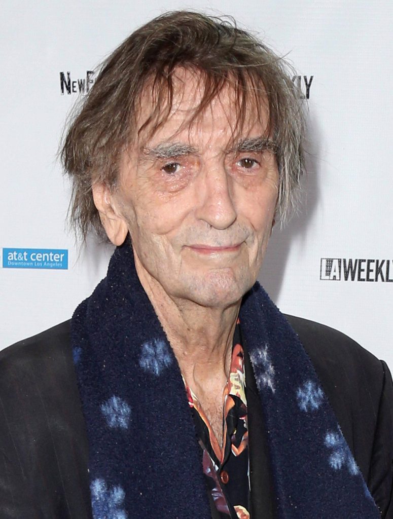 Harry Dean Stanton red carpet portrait wearing dark blazer and floral scarf with LA Weekly background Wallpaper