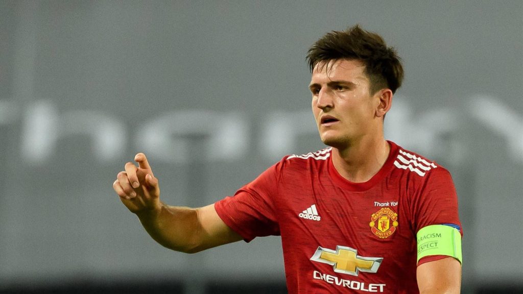 Harry Maguire in Manchester United red kit with captain armband focused during match wallpaper