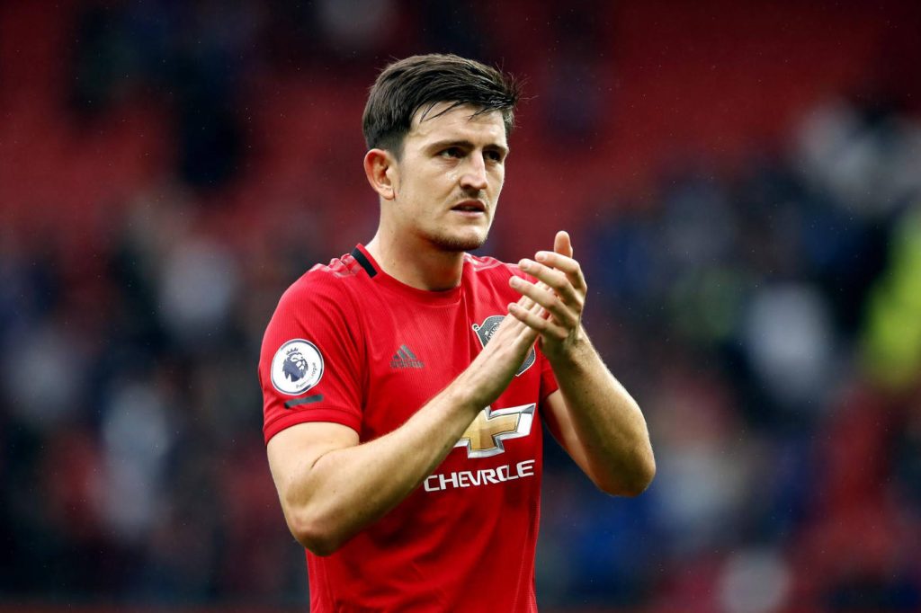 Harry Maguire Manchester United defender clapping in red kit Premier League stadium wallpaper