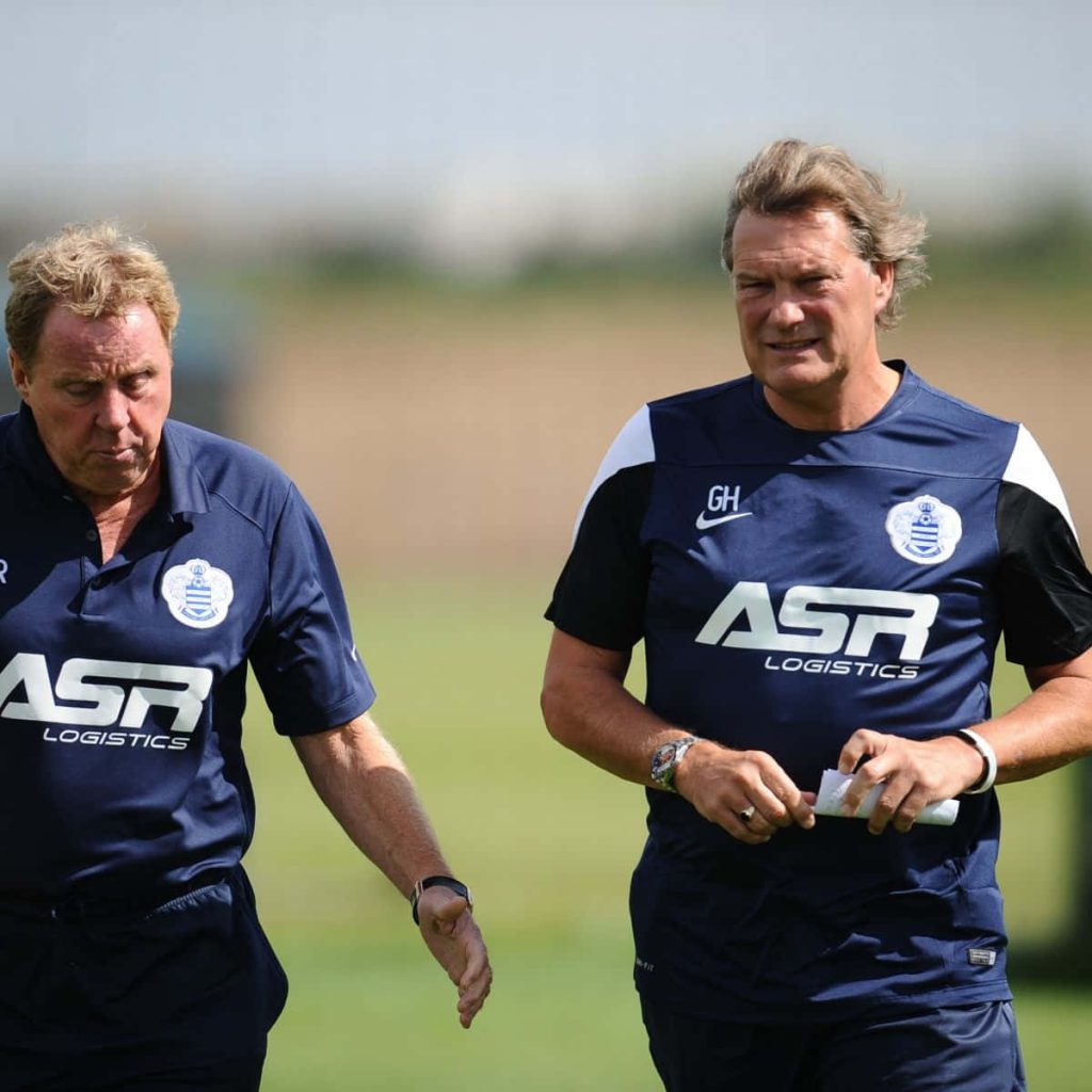 Harry Redknapp and Glenn Hoddle in navy QPR gear walking on training field focused coaching Wallpaper