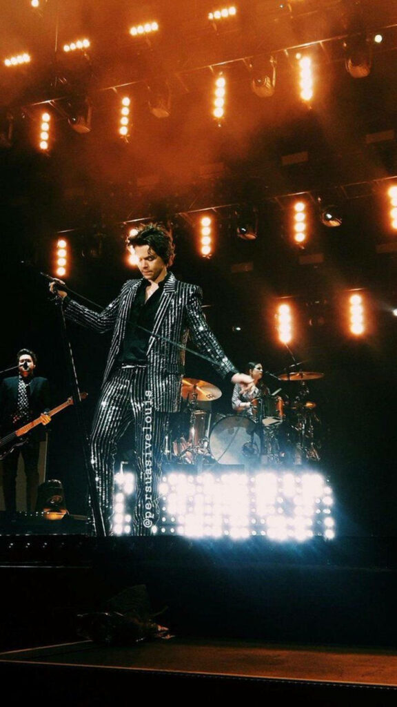 Vibrant Harry Styles Stage Performance Wallpaper Background