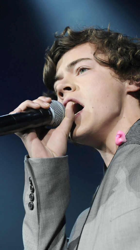 Harry Styles in Gray Suit: Dynamic Stage Performance Wallpaper
