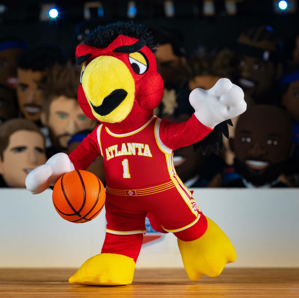 Harry The Hawk in red Atlanta Hawks uniform holding basketball with cheering fans background Wallpaper