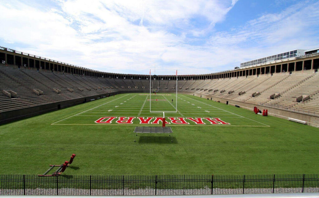 Unveiling the Magnificent Harvard University Stadium against a Radiant Azure Sky Wallpaper