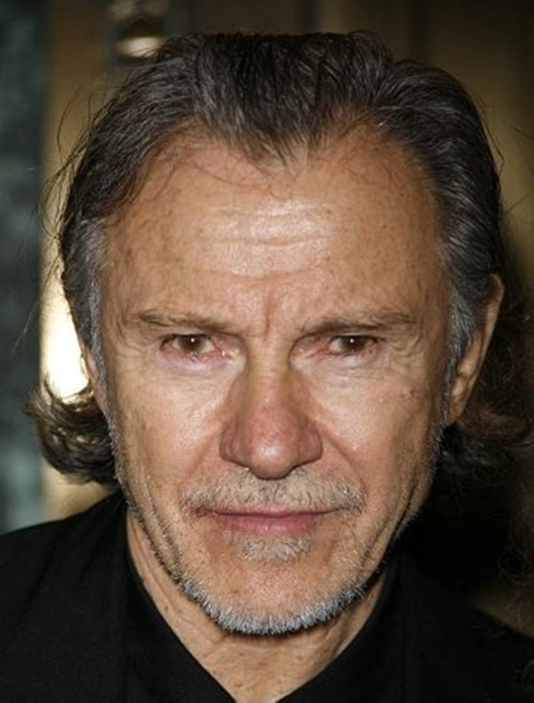 Close-up portrait of actor Harvey Keitel with piercing eyes and greying hair on dark background Wallpaper