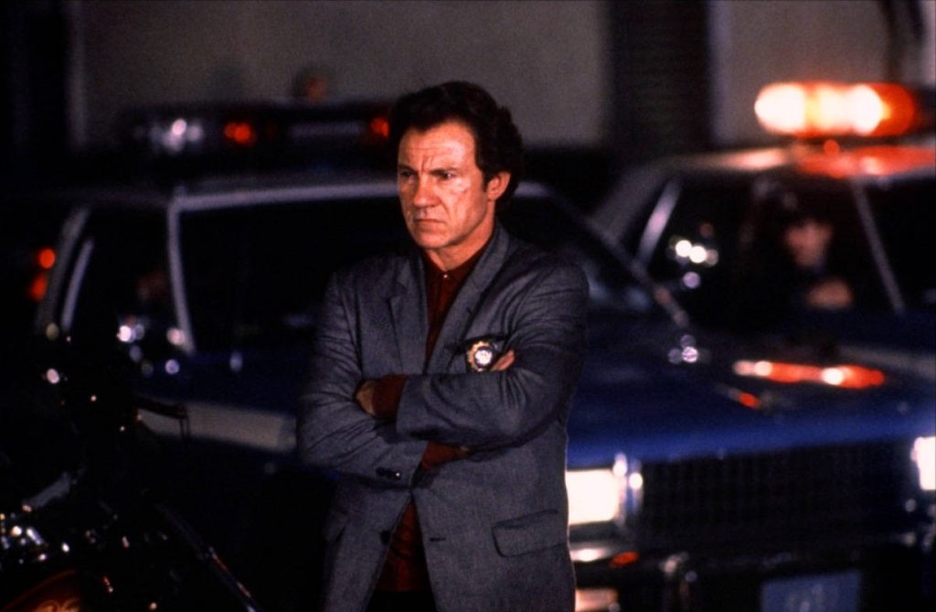 Harvey Keitel in blazer with detective badge against dark night police lights cinematic wallpaper