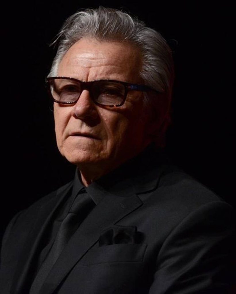 Harvey Keitel dramatic portrait black outfit thick-rimmed glasses cinematic moody lighting Wallpaper
