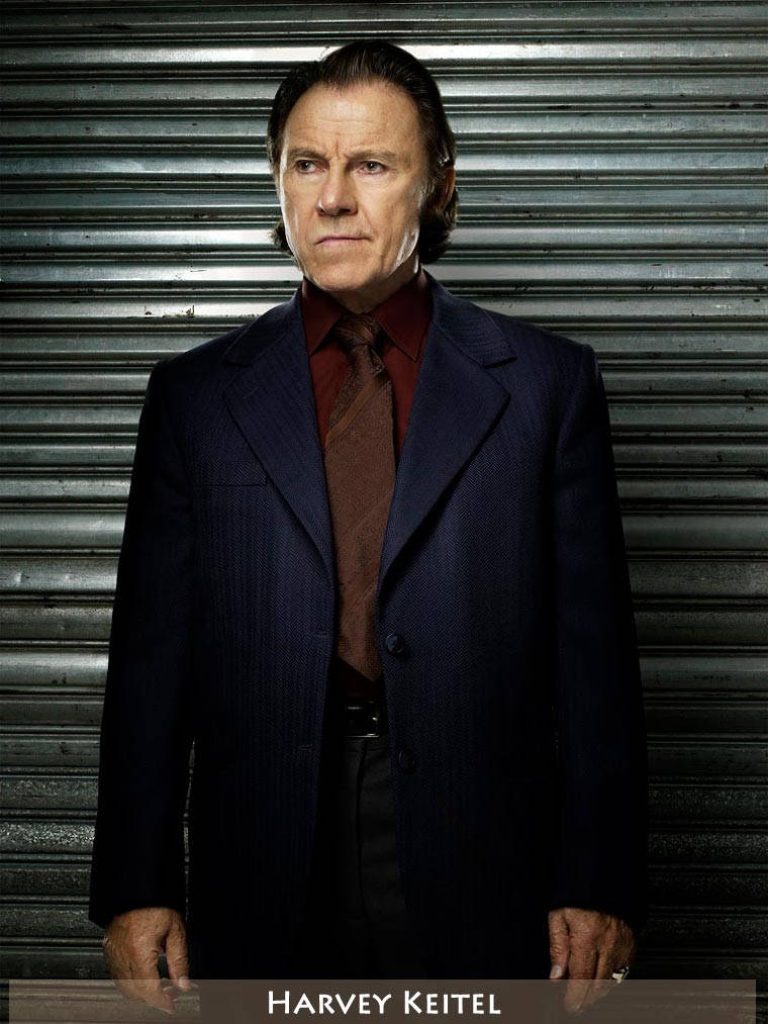 Harvey Keitel intense gaze portrait in navy suit burgundy shirt cinematic industrial background wallpaper