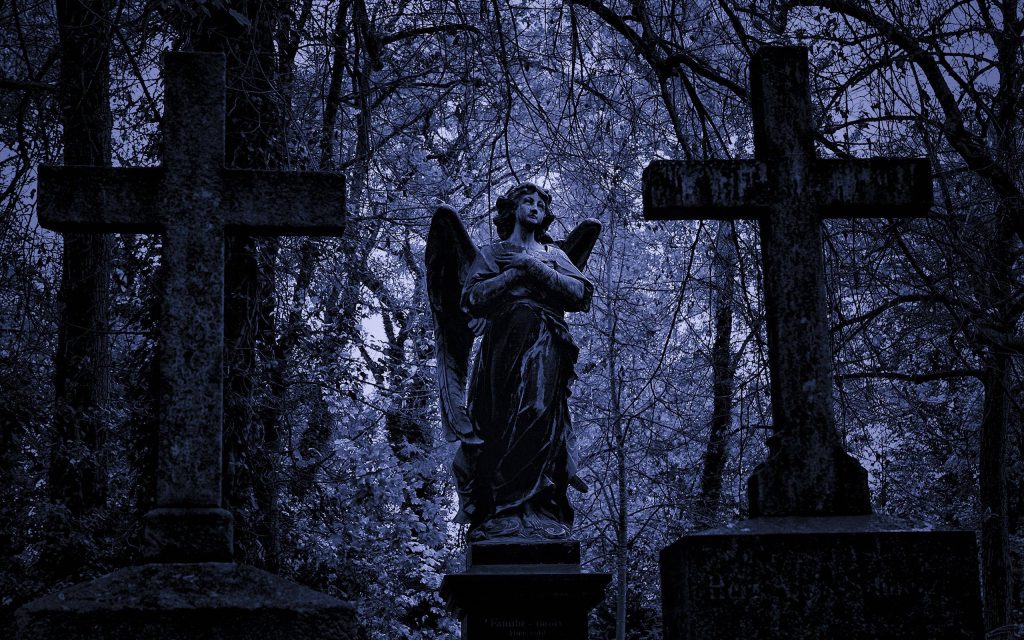 Haunting angel statue between weathered crosses in moody blue gothic graveyard forest wallpaper