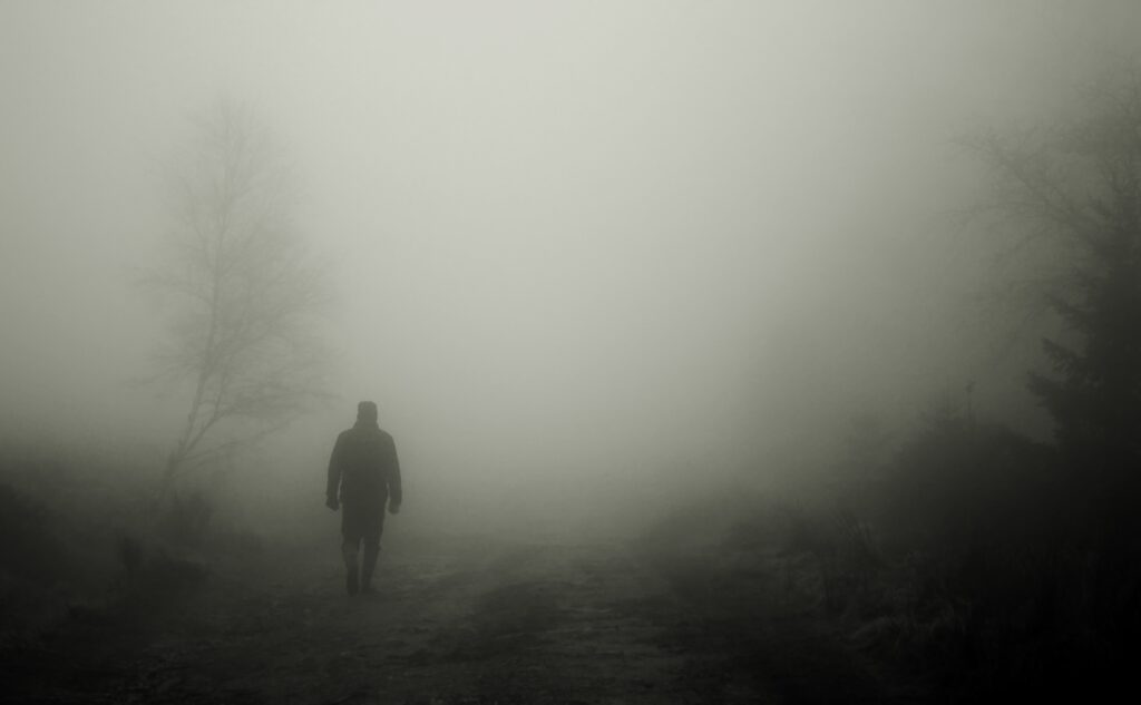 Mystical Foggy Path Wallpaper: Solitary Figure in Woods