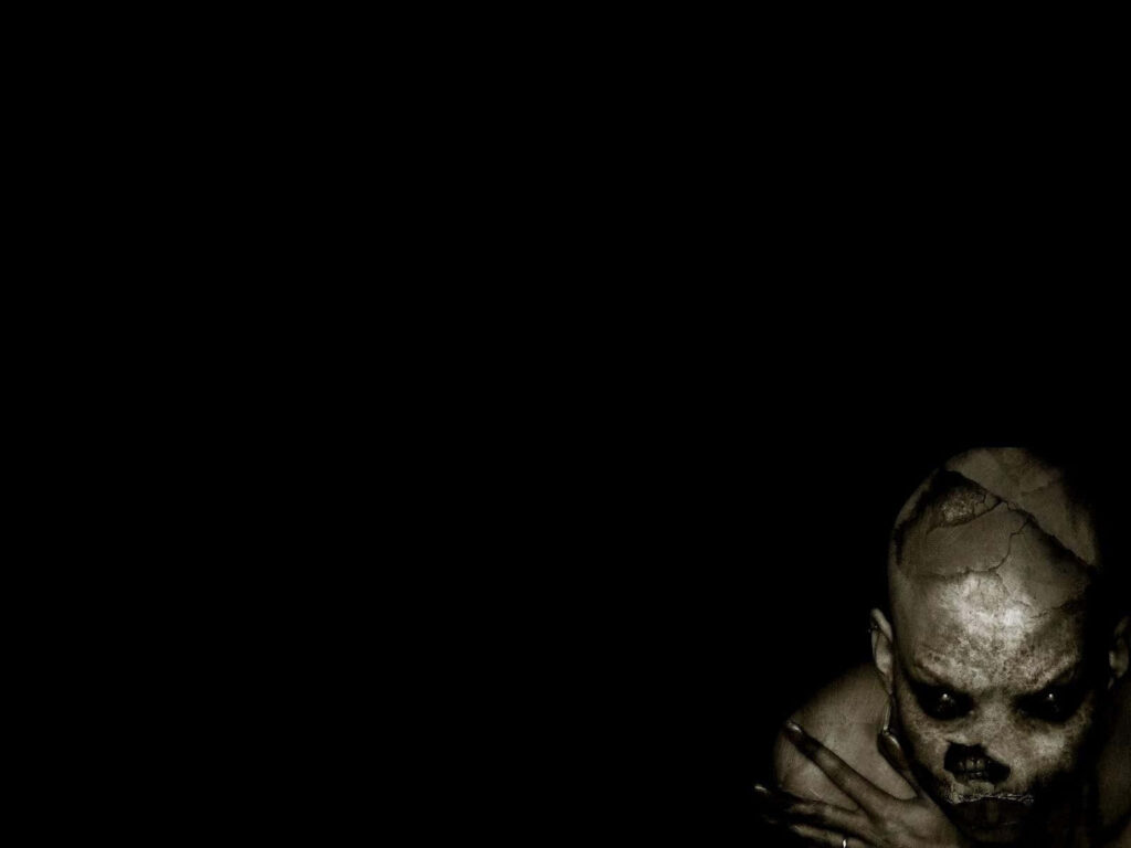 Dark menacing creature with hollow eyes emerging from shadows horror ghost wallpaper background