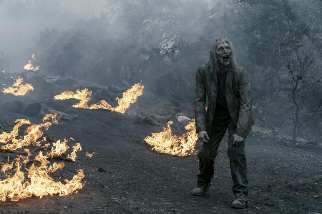 Fear the Walking Dead: Haunting Walker in Fiery Post-Apocalyptic Scene Wallpaper