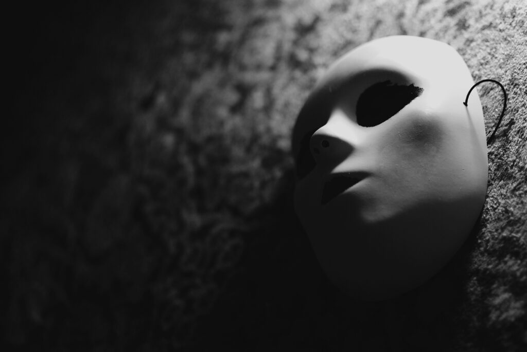 Haunting Monochrome Mask Wallpaper: Shadows & Texture Background
