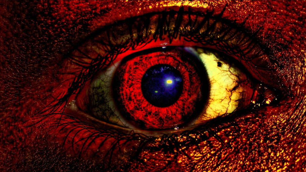 Close-up of human eye in vivid red tones with detailed iris and veins evoking evil eye theme Wallpaper
