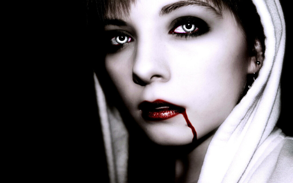 Silver eyed vampire with pale skin crimson lips and blood in shadows dark vampire wallpaper background