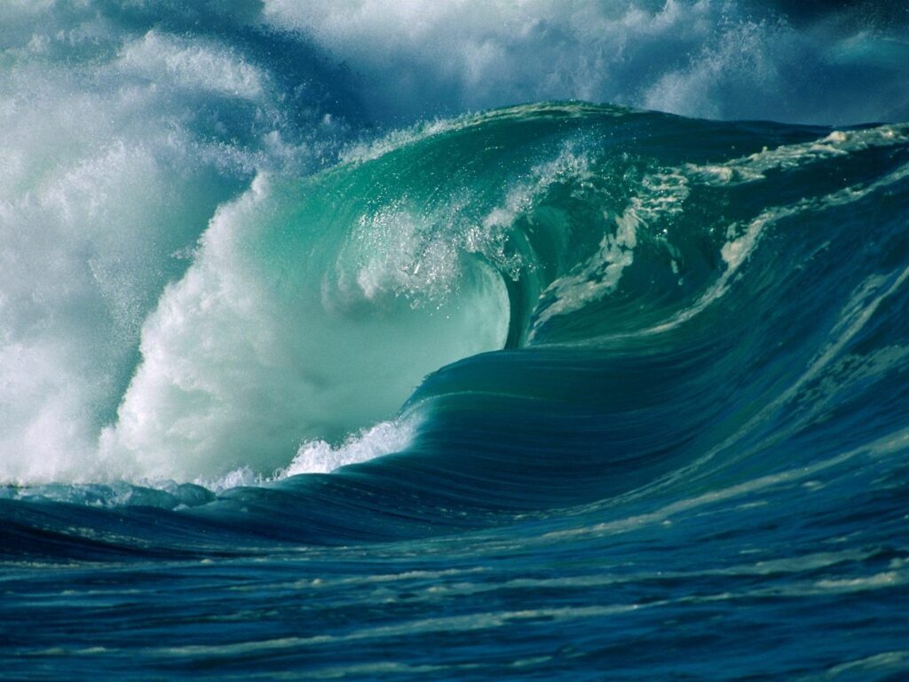 Powerful ocean wave wallpaper with deep blue turquoise hues and white foamy crests Hawaii inspired