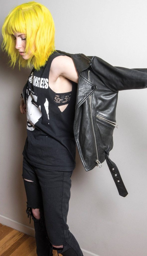 Hayley Williams punk wallpaper with yellow bob ripped jeans Misfits t-shirt leather jacket gray background