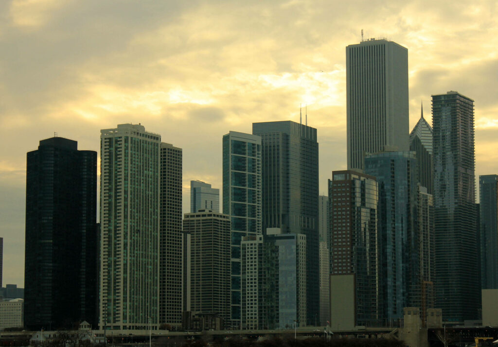 Chicago skyline at hazy afternoon with golden sunlight on modern skyscrapers wallpaper background