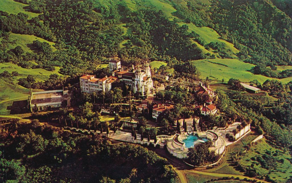 Aerial view of Hearst Castle Neptune Pool and Casa Grande mansion among green California hills Wallpaper
