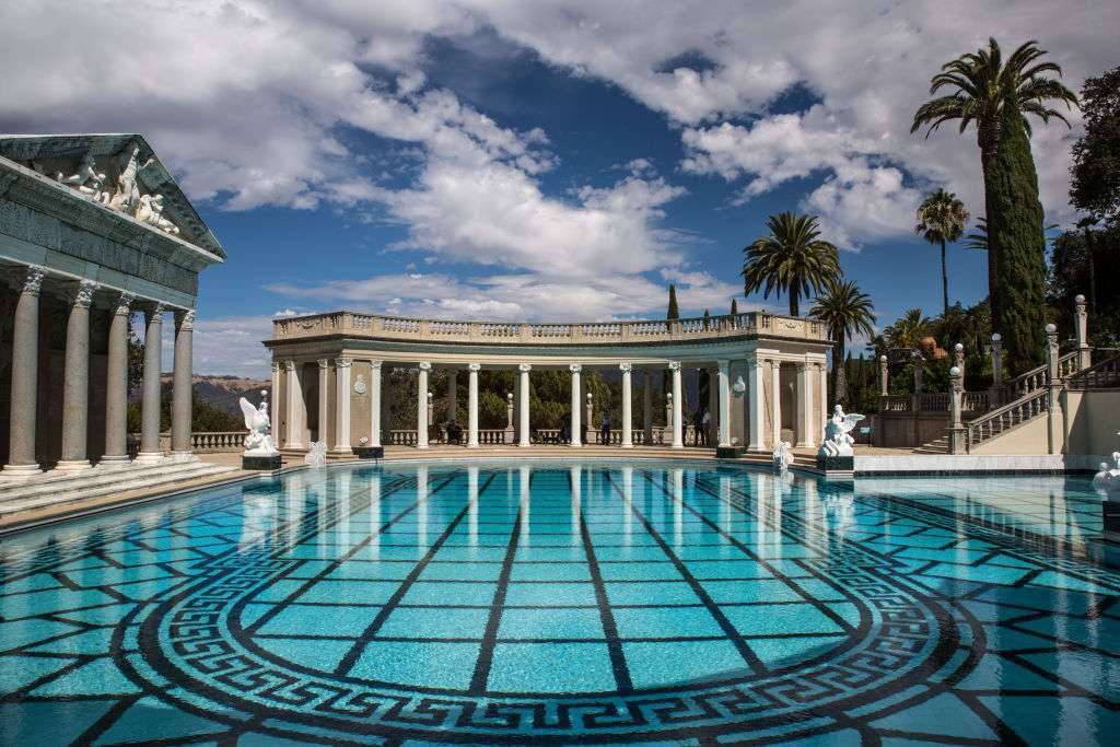 Hearst Castle Neptune Pool turquoise water mosaic floor neoclassical columns white statues palms Wallpaper