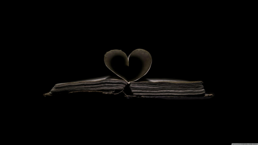 Heart-Shaped Book Silhouette Wallpaper on Dark Background