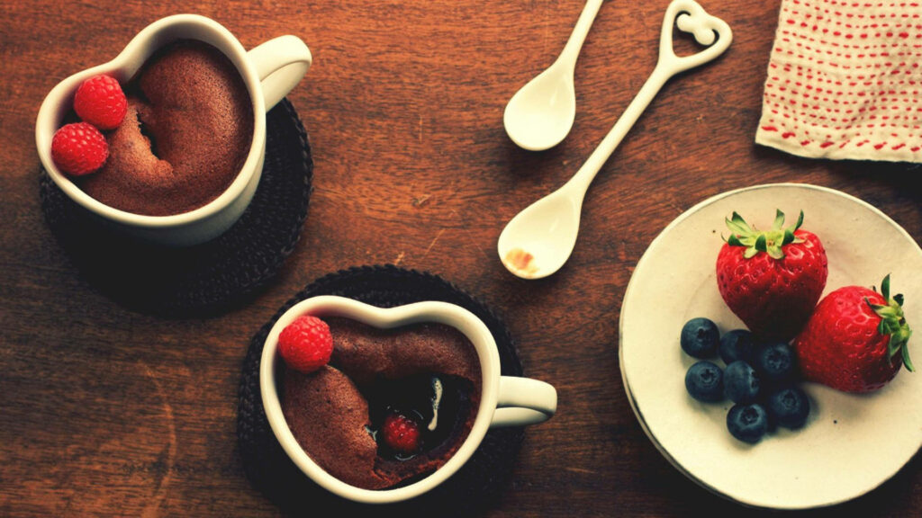 Rich chocolate brownies with fresh raspberries in heart cups on rustic wooden table dessert scene Wallpaper