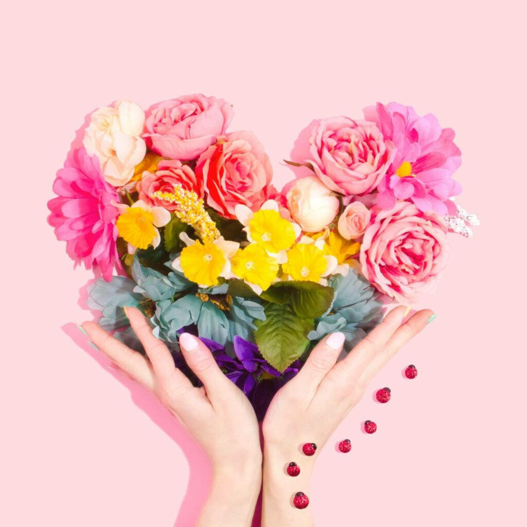Heart-Shaped Floral Bouquet Wallpaper on Soft Pink Background