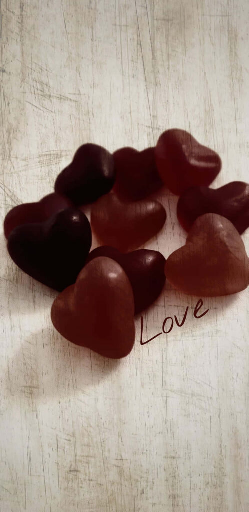 Heart-Shaped Objects on Textured Surface: Love Symbol Wallpaper
