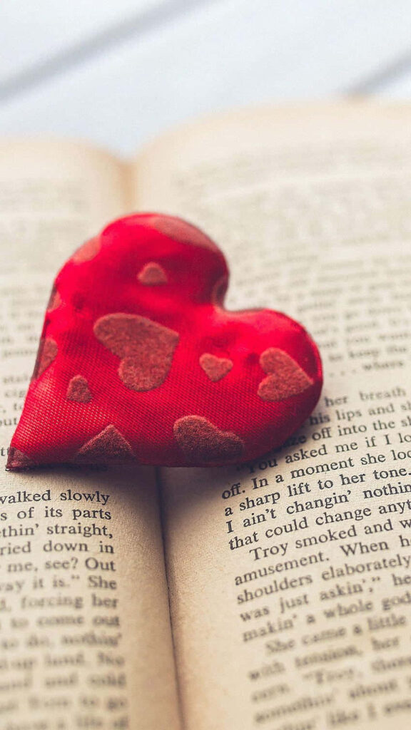 Love & Warmth: Heart Ornament on Book - Wallpaper Background