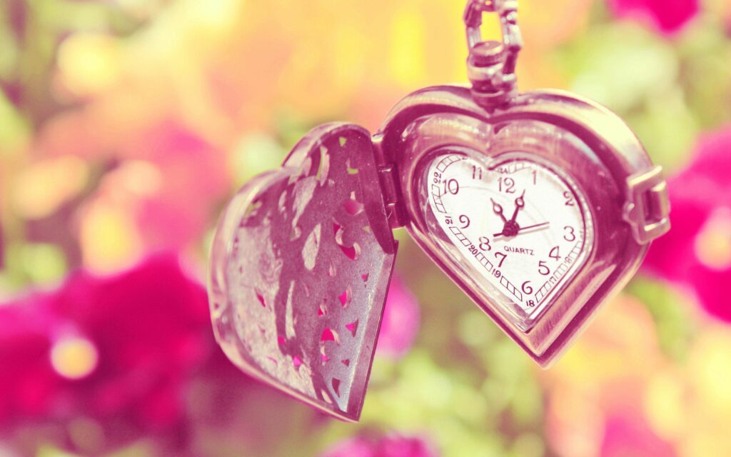 Heart-Shaped Pocket Watch: Intricate Design Among Summer Flowers Wallpaper