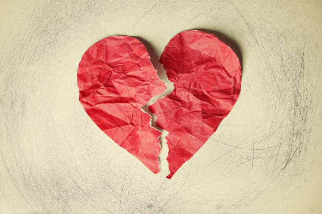 Heartbreak Wallpaper: Crumpled Red Paper Heart on Textured White