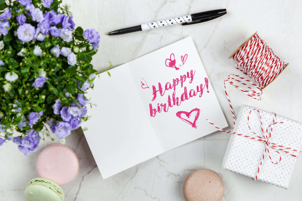 Heartfelt Birthday Celebration Wallpaper with Flowers & Pastel Macarons