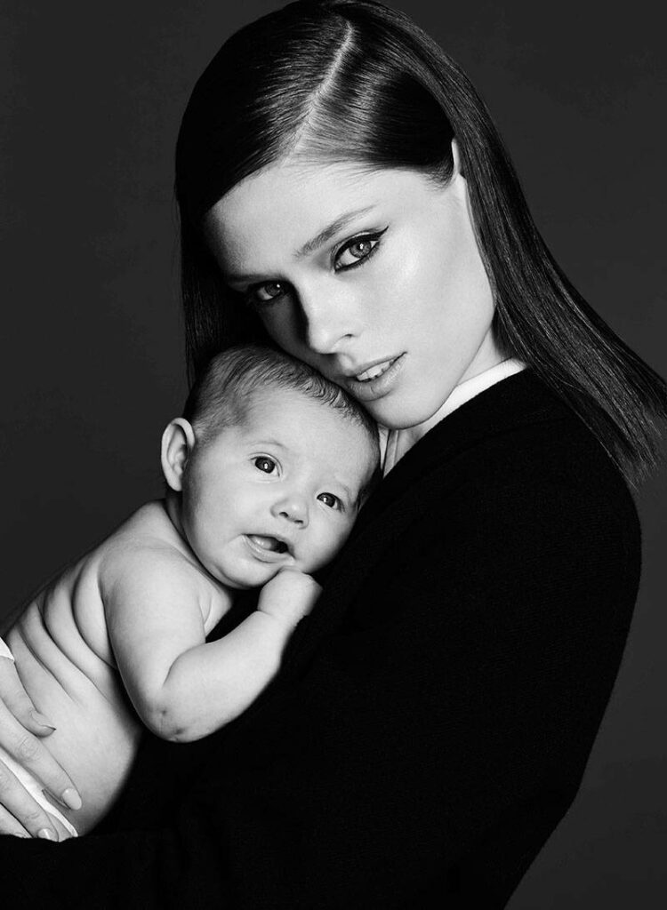 Nurturing Bond: Mother and Baby Daughter in Black and White Wallpaper