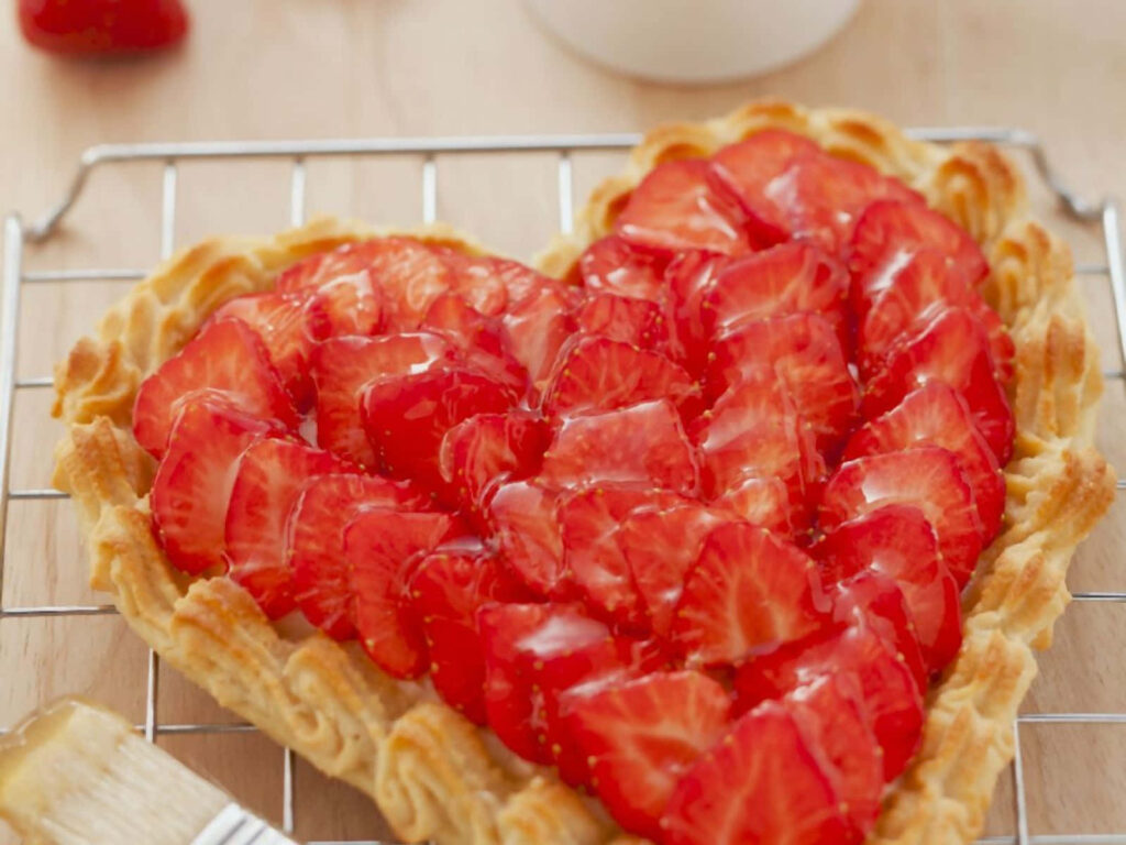 Heartfelt Delight: A Strawberry-Adorned Freshly Baked Tart Wallpaper
