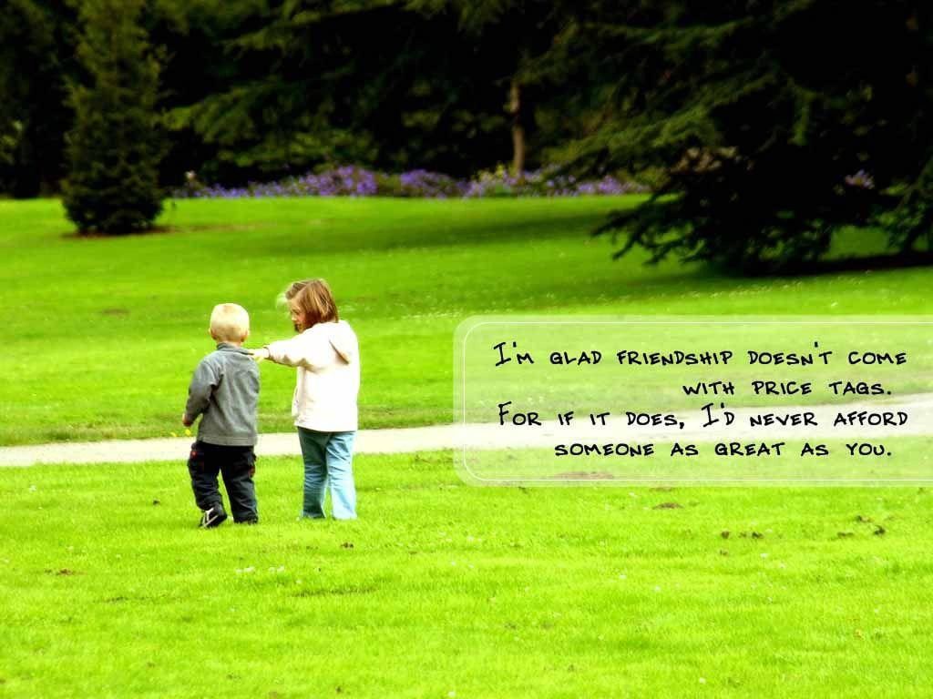 Two young friends walk in a green park with friendship quote overlay inspiring connection joy Wallpaper