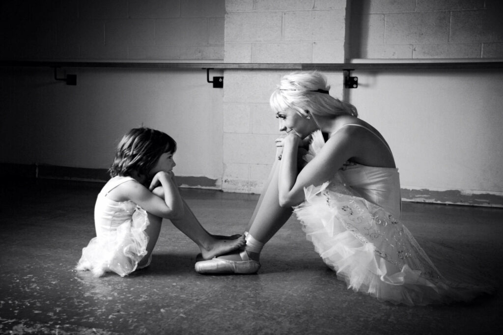 Intimate Mother-Daughter Moment in Ballet Studio Wallpaper