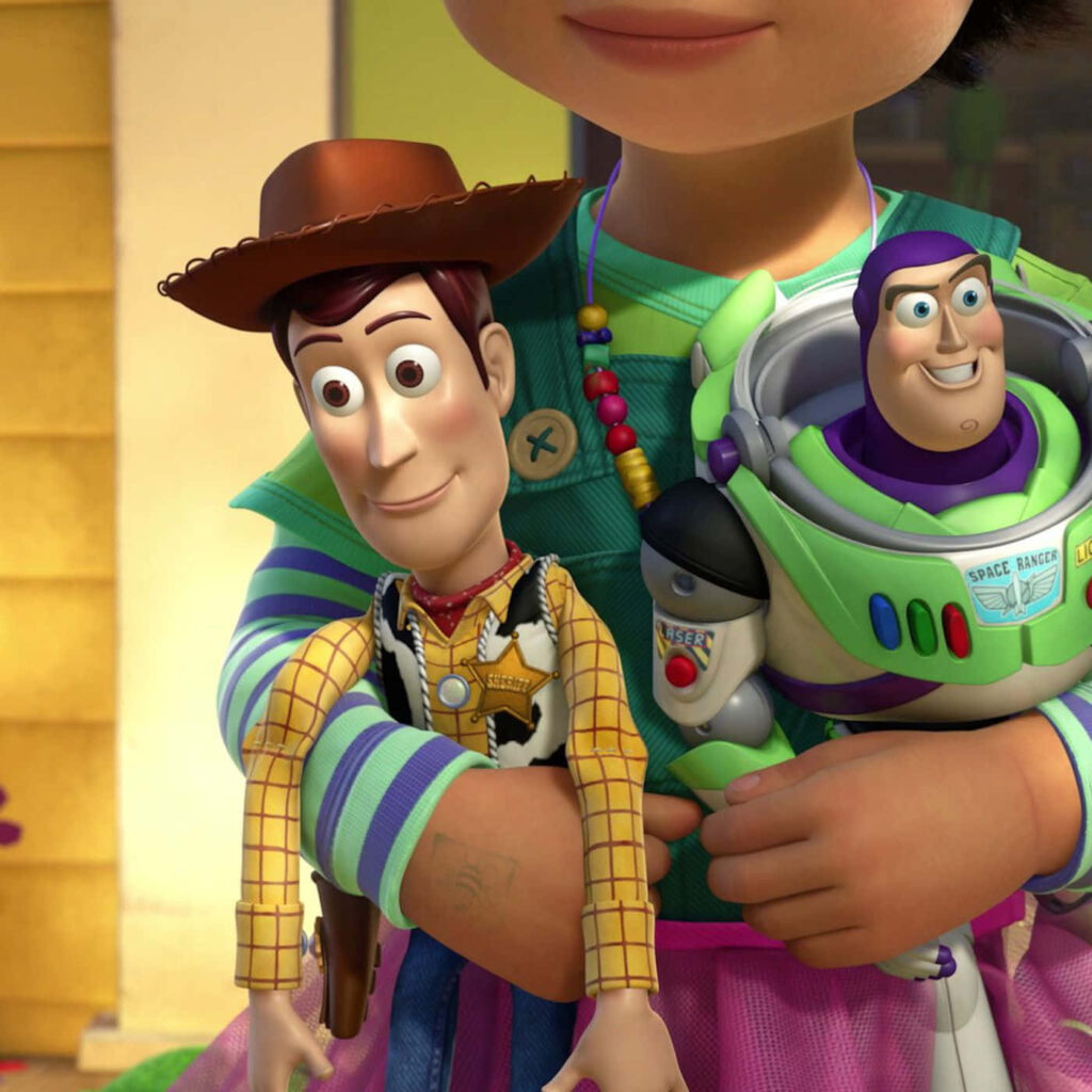 Vibrant Toy Story Wallpaper: Woody & Buzz with a Child's Embrace