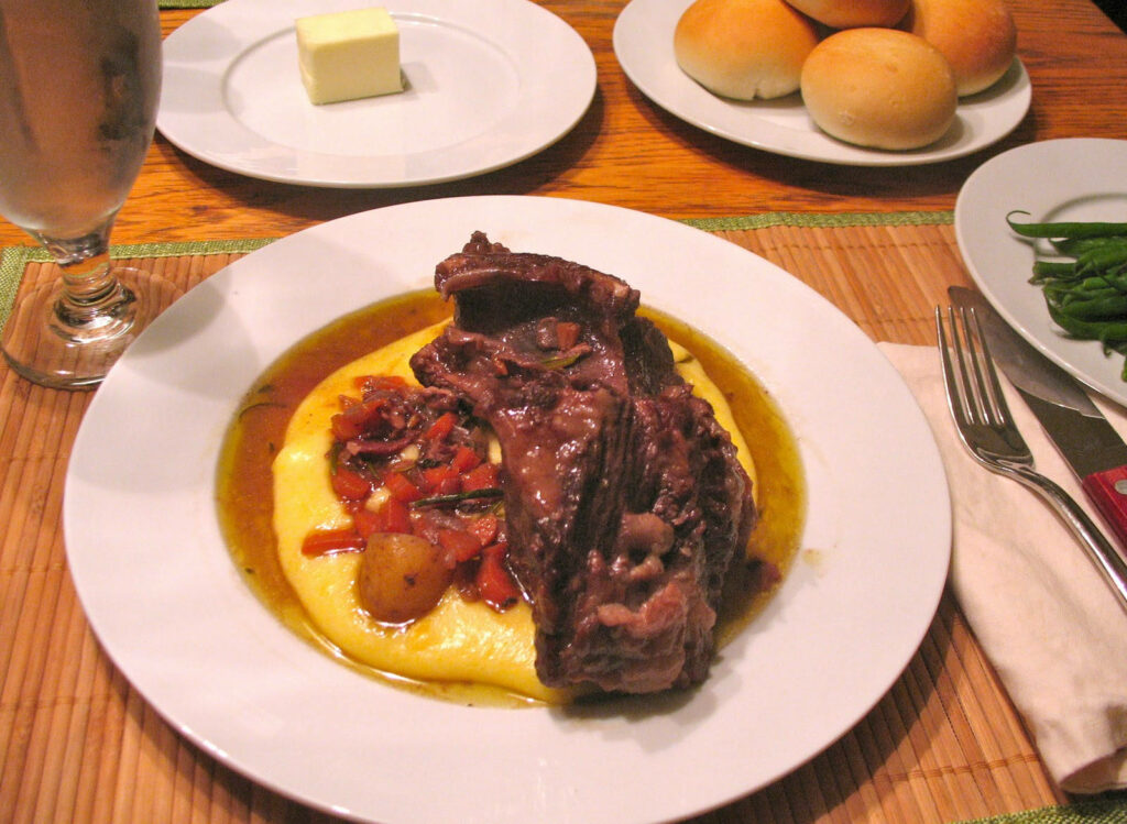 Comforting Beef Over Creamy Polenta: Savory Meal Wallpaper