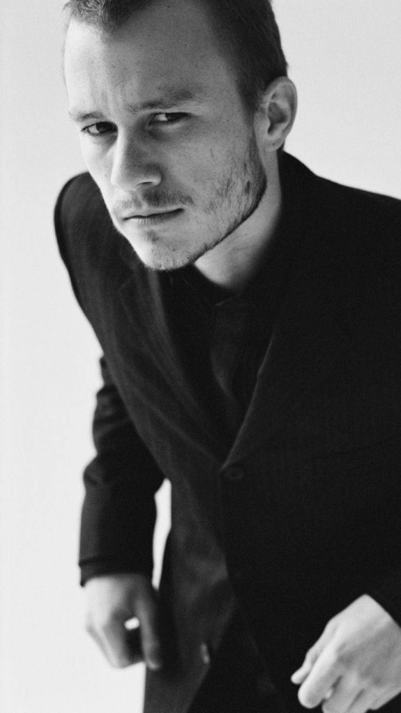 Heath Ledger intense gaze black and white portrait sharp coat minimalist background wallpaper