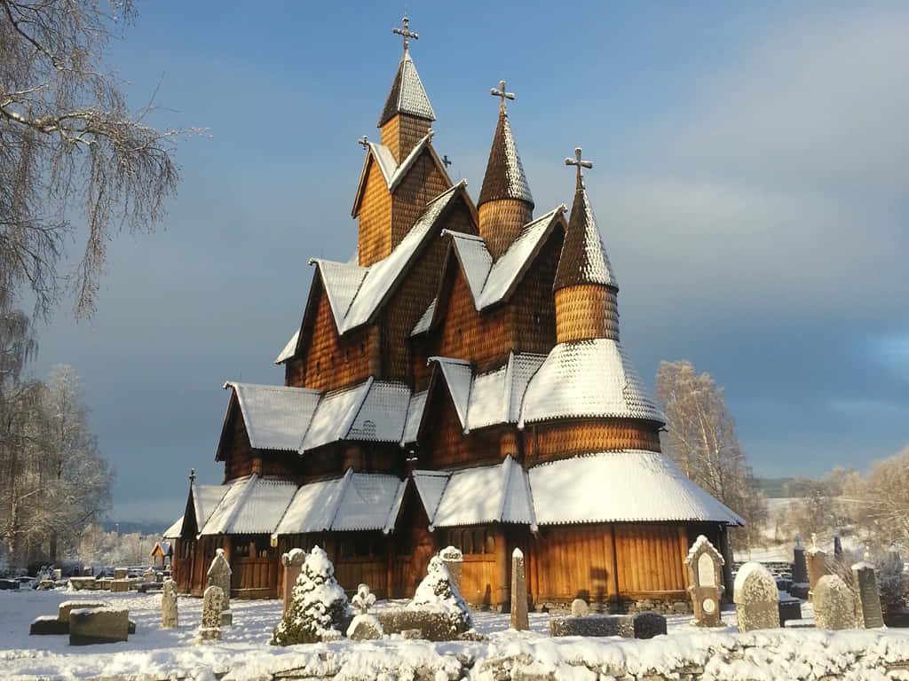Heddal Stave Church in Norway winter snow-dusted roofs frozen graveyard traditional architecture Wallpaper