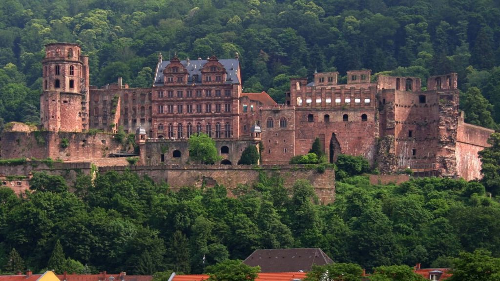 Heidelberg Castle red sandstone ruins with lush green forest historic German landmark wallpaper