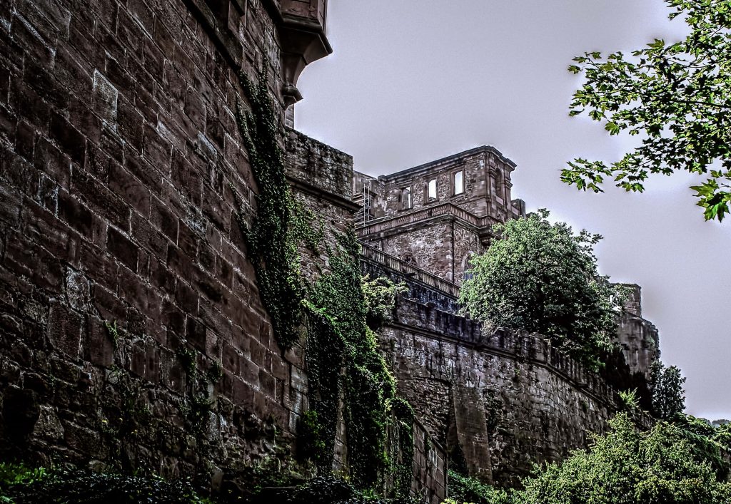 Heidelberg Castle ivy-covered red sandstone walls historic ruins dramatic overcast sky wallpaper