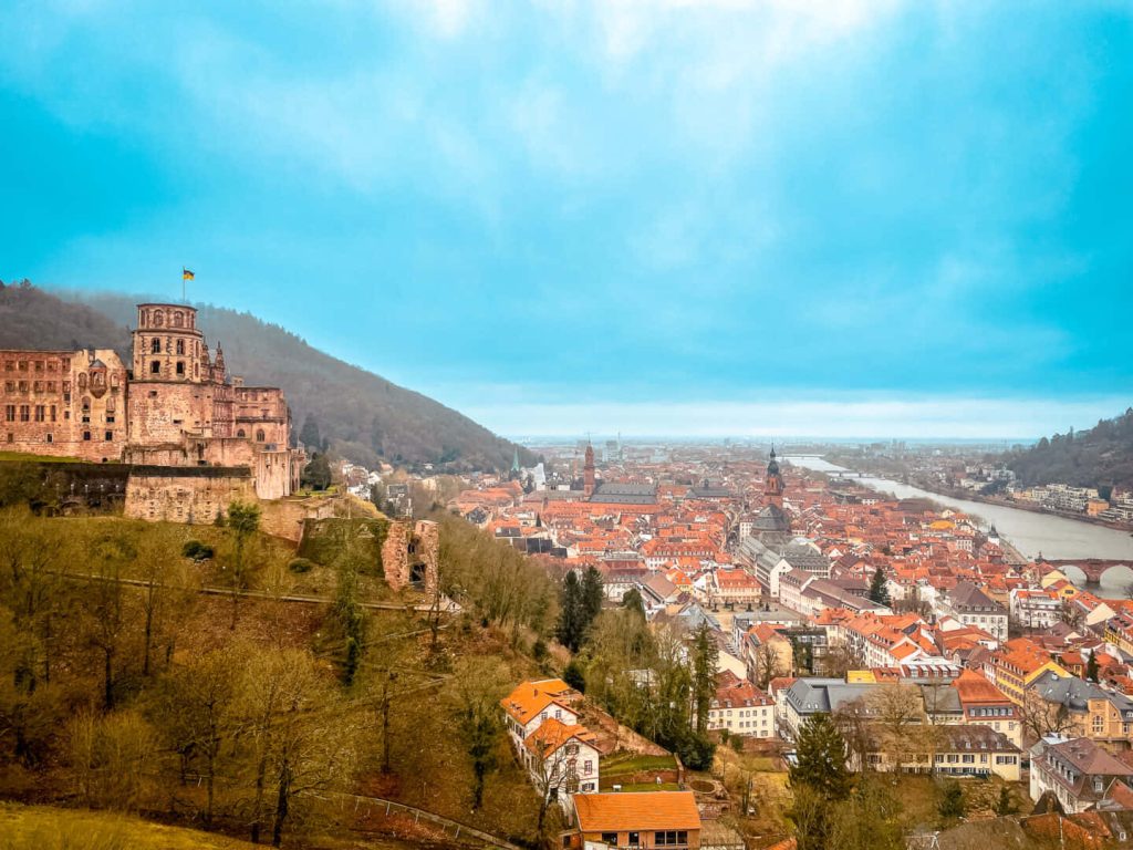 Heidelberg Castle ruins overlooking red-roofed old town and Neckar River cityscape wallpaper