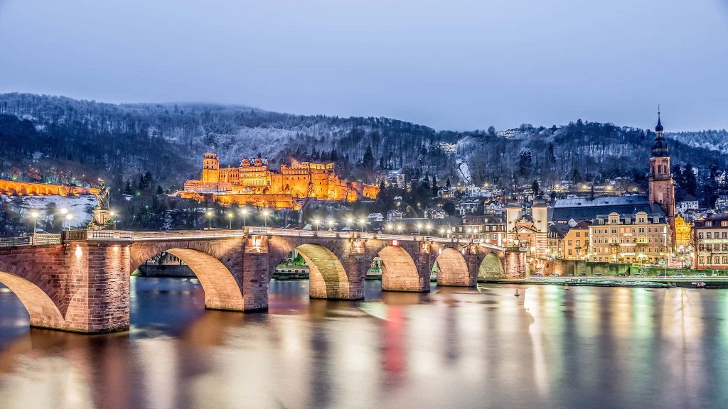 Heidelberg Castle and Old Bridge illuminated at twilight winter snow Neckar River Germany wallpaper