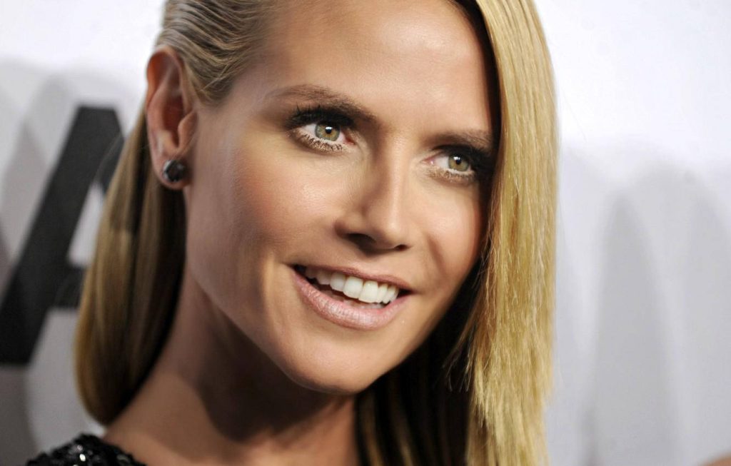 Heidi Klum close-up with side-swept hairstyle radiant smile and studio lighting wallpaper background