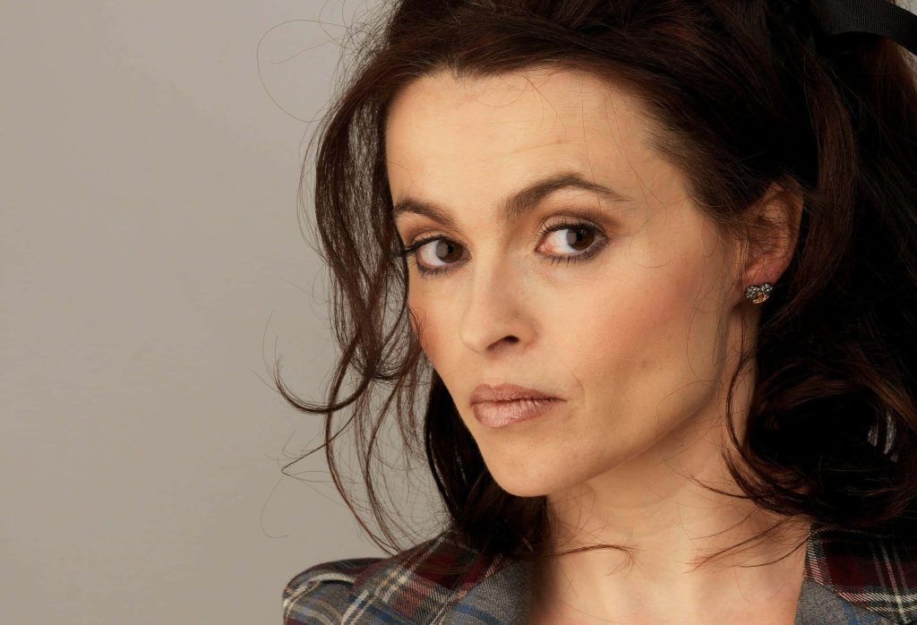 Close-up portrait of Helena Bonham Carter with dark hair and plaid blazer in studio lighting Wallpaper